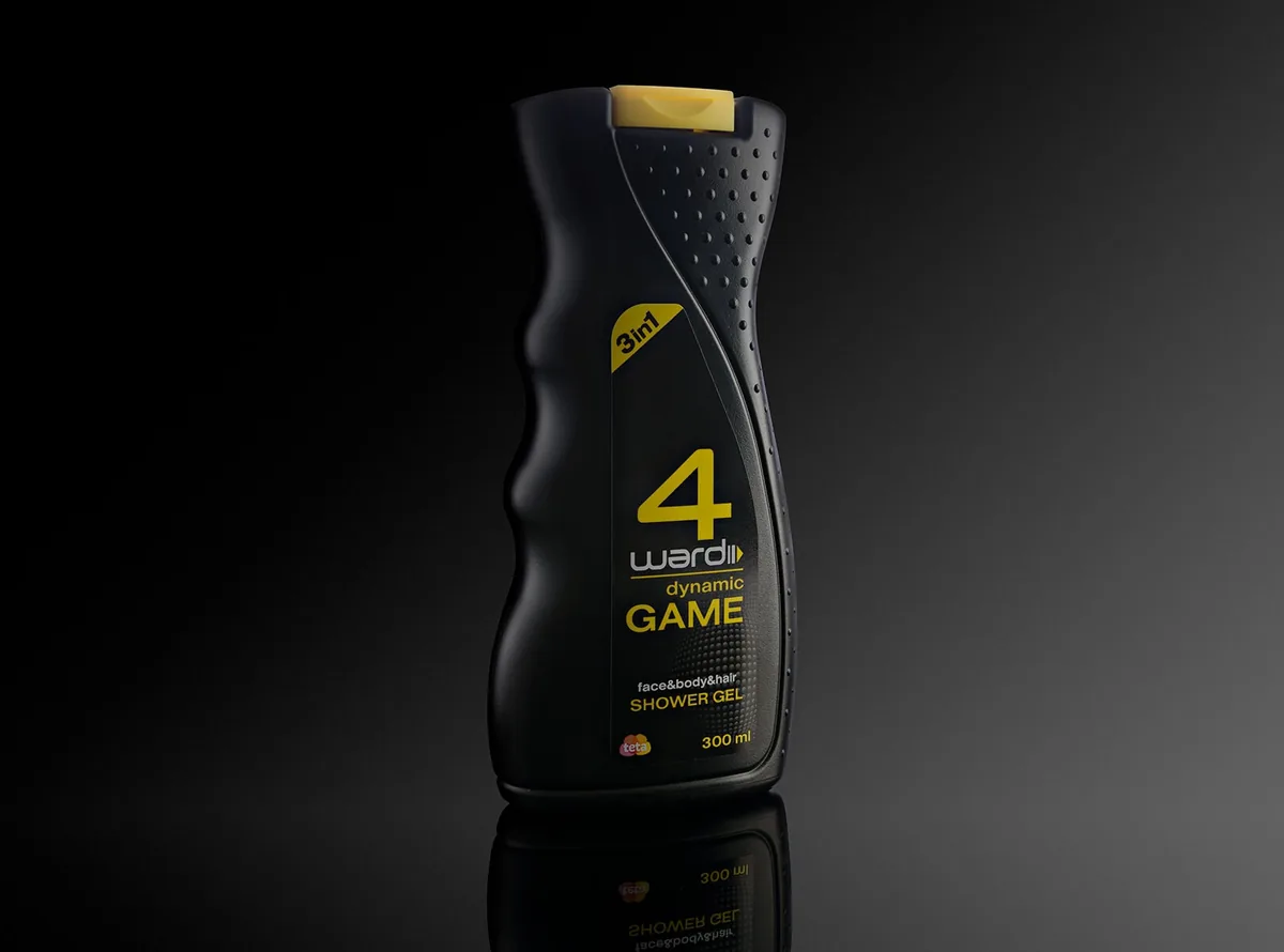 Black shower gel bottle with yellow lettering